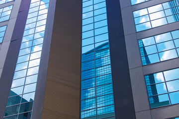 A cityscape of moving cloud reflecting the office building at the business town