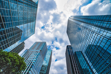 A cityscape of moving cloud reflecting the office building at the business town