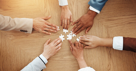 Hands, above and puzzle for team at office with solution, synergy and strategy for game at company....