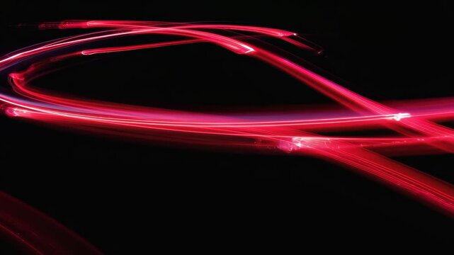Dynamic Red Light Trails in Abstract Motion on Black Background
