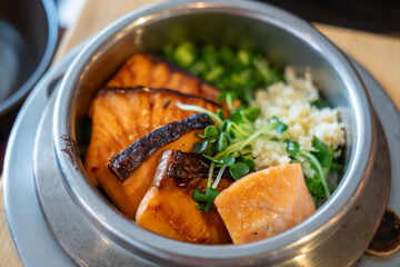 Grilled salmon with rice in a steamed pot. Korean food