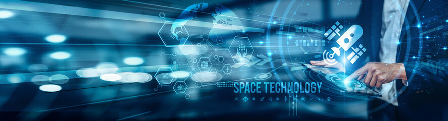 A businessman using a tablet is analyzing space technology by reviewing data-driven space team...