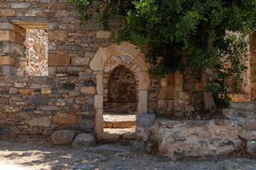 Historical ruins of Spinalonga showcasing stone architecture and ancient walls in Crete Greece