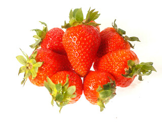 Fresh and juicy red strawberry in a pile on white background. Premium high quality organic product. Food supply industry.