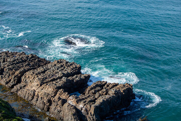 Aerial View of Rocky Coastline with Waves