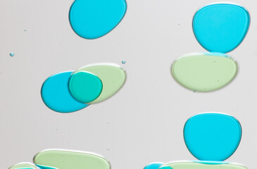 Abstract Close-Up of Colorful Liquid Bubbles on a Clear Surface