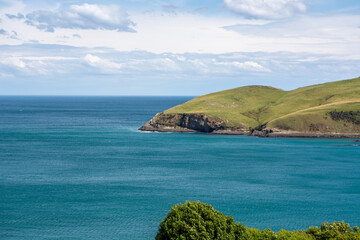 Scenic Coastal View with Green Hills and Blue Ocean