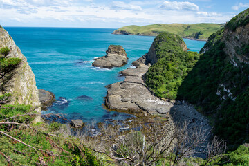 Scenic Coastal View with Turquoise Waters and Lush Cliffs