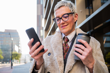 Professional woman engaging with technology in urban setting