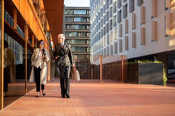 Businesswomen walking through modern office building in barcelona