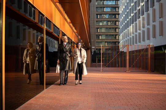 Professional women walking in modern barcelona business district