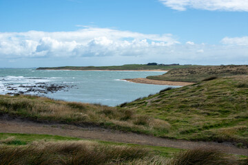 Scenic Coastal Landscape with Green Hills and Sandy Beach