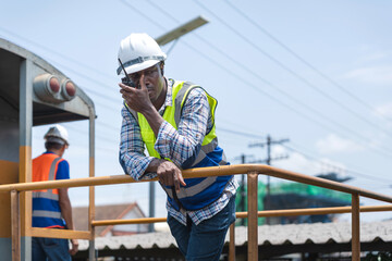 Railroad Worker Communicating on Walkie-Talkie by Train, Industrial Engineer Using Radio on a Train...