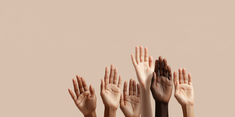 Obraz premium Multiple raised palms showcase beautiful human diversity against soft beige backdrop.
