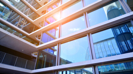 Modern office building with glass facade. Transparent glass wall of office building. Reflection of...