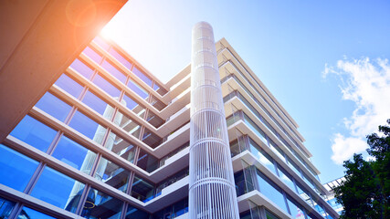 Modern office building with glass facade. Transparent glass wall of office building. Reflection of...