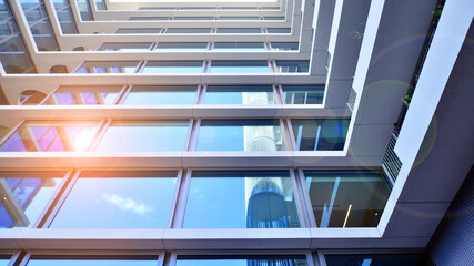 Modern office building with glass facade. Transparent glass wall of office building. Reflection of...