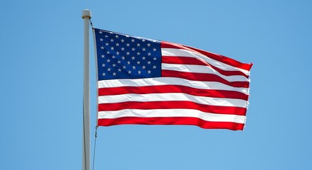 An american flag billows gently in the breeze against a bright blue sky