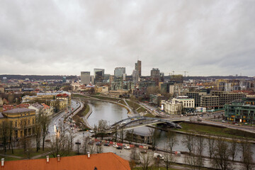 Obraz premium Overcast view of modern city part in Vilnius with River floating in the middle, Cloudy day, Lithuania