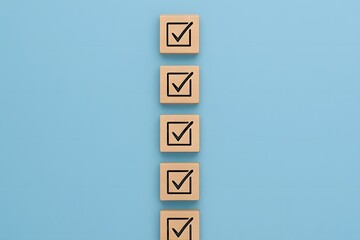Five wooden blocks with checkmarks in a vertical line on a blue background