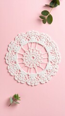 Delicate White Lace Circular Motif on Blush Pink Background with Greenery Elements