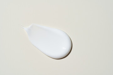 Luxurious cream dabbed and blended on neutral surface, highlighting smooth application for...
