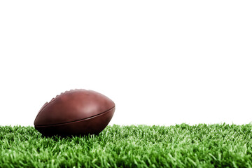 Brown football on green grass isolated on a transparent background