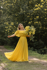 Fototapeta premium Yellow Dress Woman Spring Flowers Photography: Outdoor Portrait, Cheerful Model Posing, Sunny Day