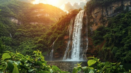 A powerful waterfall cascading down a cliff, surrounded by lush green forest