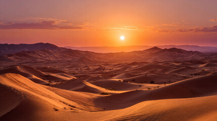 Sunrise over the dramatic sand dunes of the Sahara Desert near Merzouga, Morocco--featuring warm orange hues