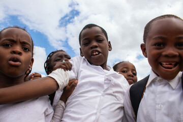 Happy African children in school uniforms enjoying time together outdoors. A genuine moment that reflects joy, education, and the powerful connection between learning. 