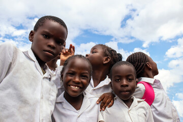 Happy African children in school uniforms enjoying time together outdoors. A genuine moment that reflects joy, education, and the powerful connection between learning. 