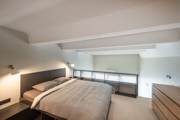 Contemporary Loft Bedroom Interior With Walk-In Closet and Minimalist Design Elements