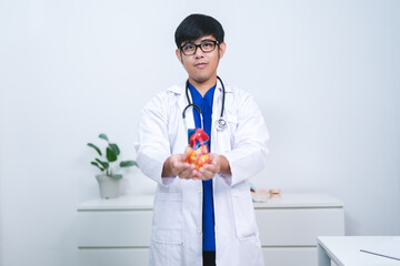 The cardiologist used a stethoscope to check the patient’s heartbeat, providing medicine and...