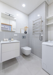 Modern Bathroom With White Sink, Toilet, and Washing Machine in Minimalist Design