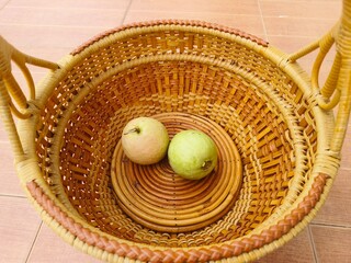Red-fleshed guava in a glazed wicker basket