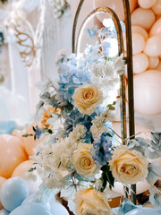 Elegant floral arrangement with pastel decorations in a celebration setting
