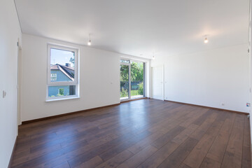 Obraz premium Spacious Modern Living Room Interior with Hardwood Floors and White Walls