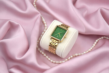 Closeup minimal fashion wristwatch for women on pink background.