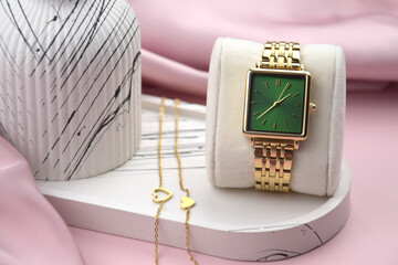 Closeup minimal fashion wristwatch for women on pink background.