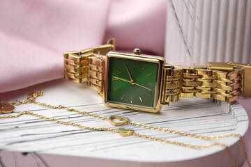 Closeup minimal fashion wristwatch for women on pink background.