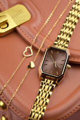 Closeup minimal fashion wristwatch for women on pink background.