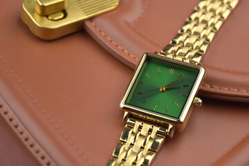 Closeup minimal fashion wristwatch for women on pink background.