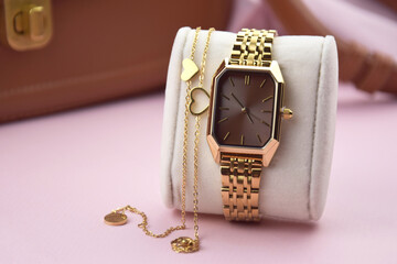 Closeup minimal fashion wristwatch for women on pink background.