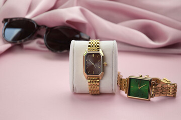Closeup minimal fashion wristwatch for women on pink background.