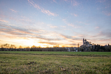 A winter landscape shot at sunrise. Plenty of nature and a large church on a rock. The former collegiate church of St. Lubentius Limburger, Dietkirchen, Hesse