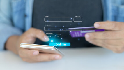 Close-up of man using smartphone and credit card for online payment and mobile banking transaction,...