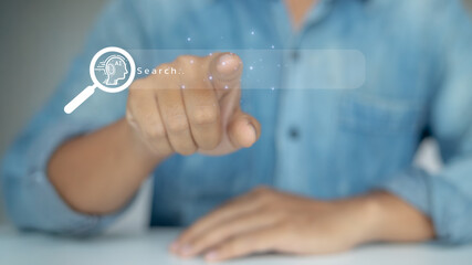 Businessman pointing virtual search bar with AI technology icon, representing artificial...