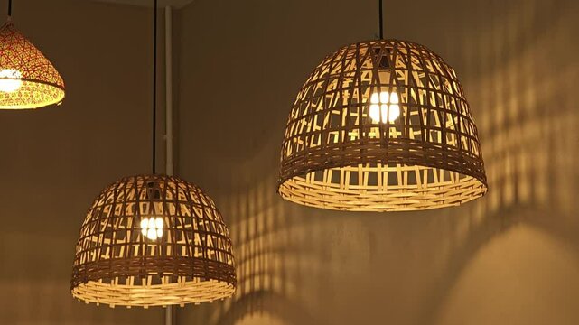 Hanging woven bamboo lamp with warm glowing lights.
