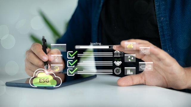 Hand using tablet with ESG icons representing environmental, social, and governance for sustainable development and green business concept. - Powered by Adobe